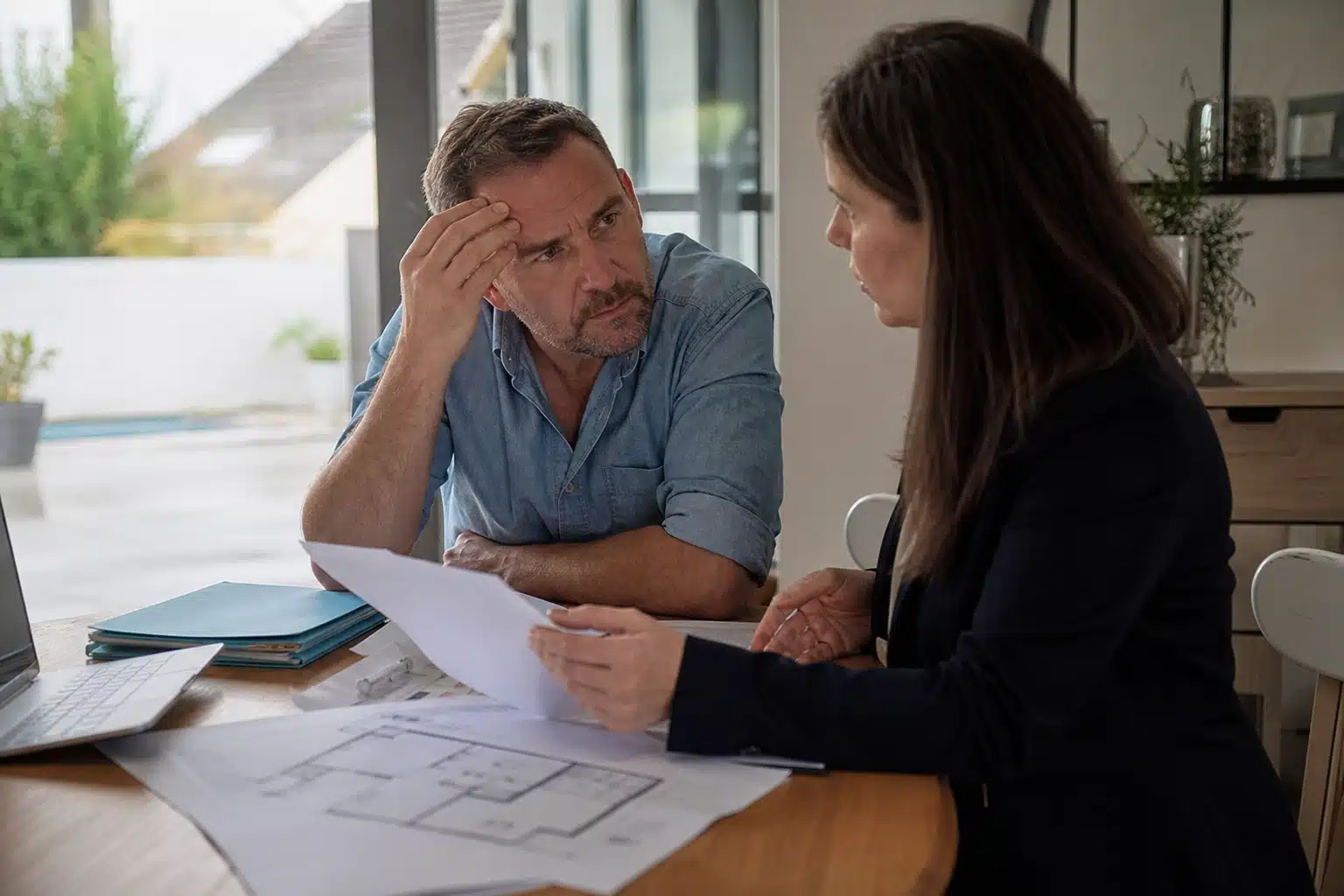 Homme préoccupé et femme examinant des documents